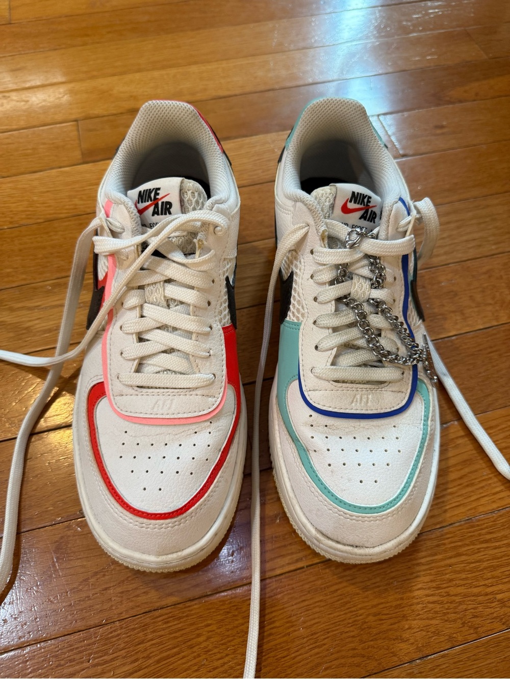 Nike woman’s White Sneakers with Red, Pink, Teal and Blue Accents barely used